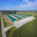 an arial view of four barns with green roofs