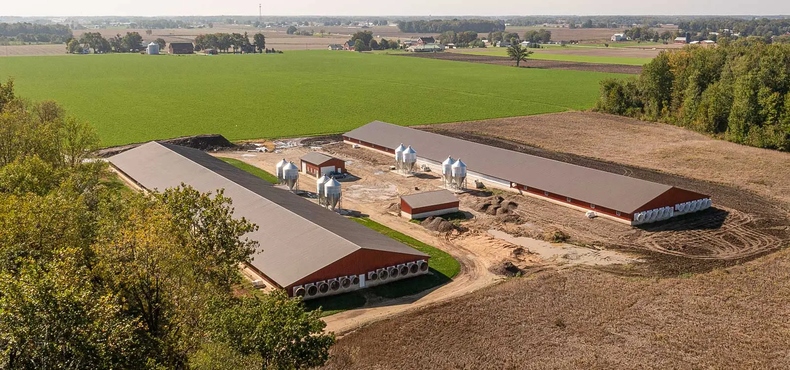 Arial view of two large red ag barns