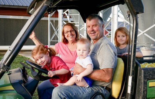 the stutzman family sitting on a gator